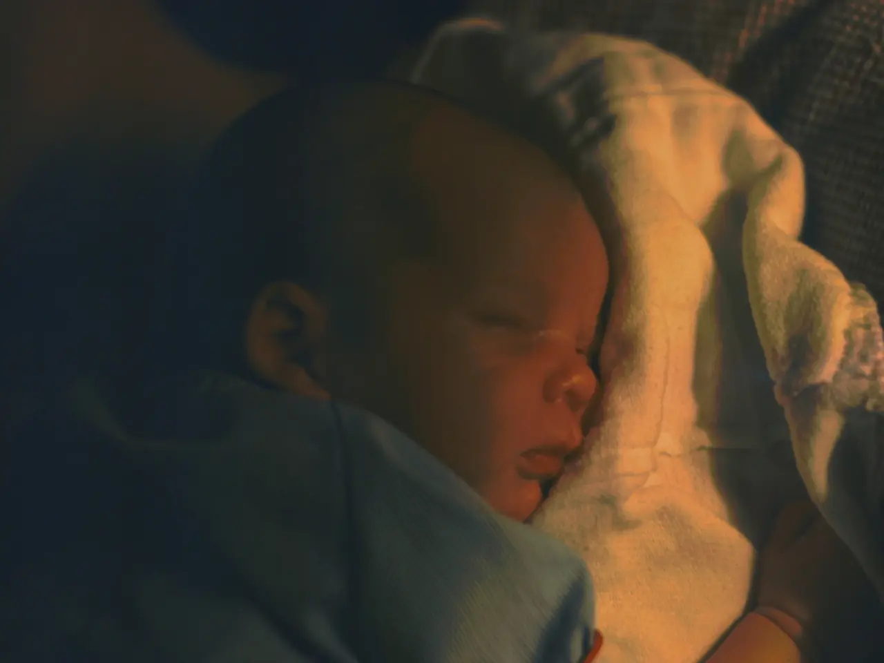 In this picture I can see a baby who is lying on a cloth.