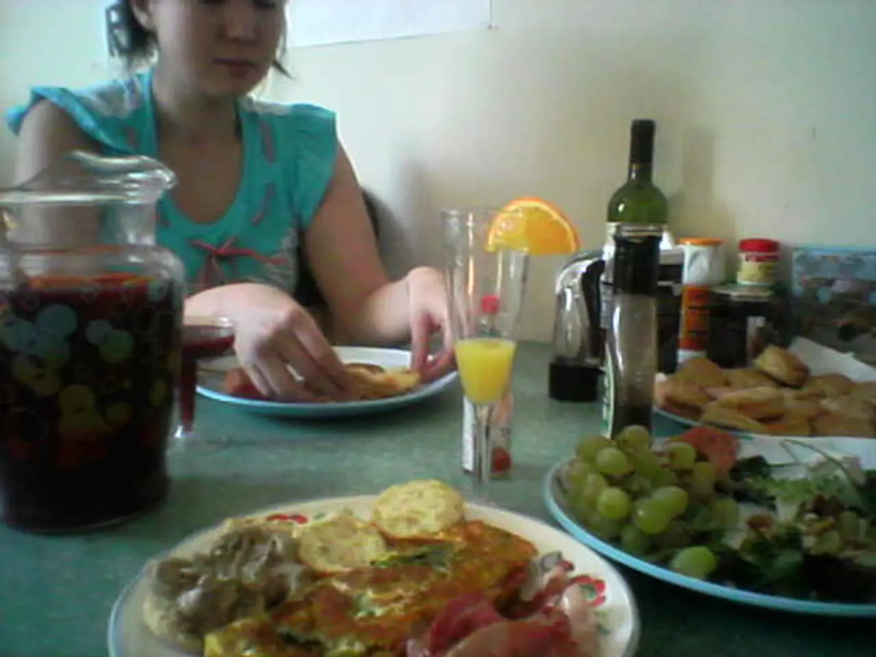 In this picture there is a woman who is sitting on the chair. There is a jar, glass, bottle, box...