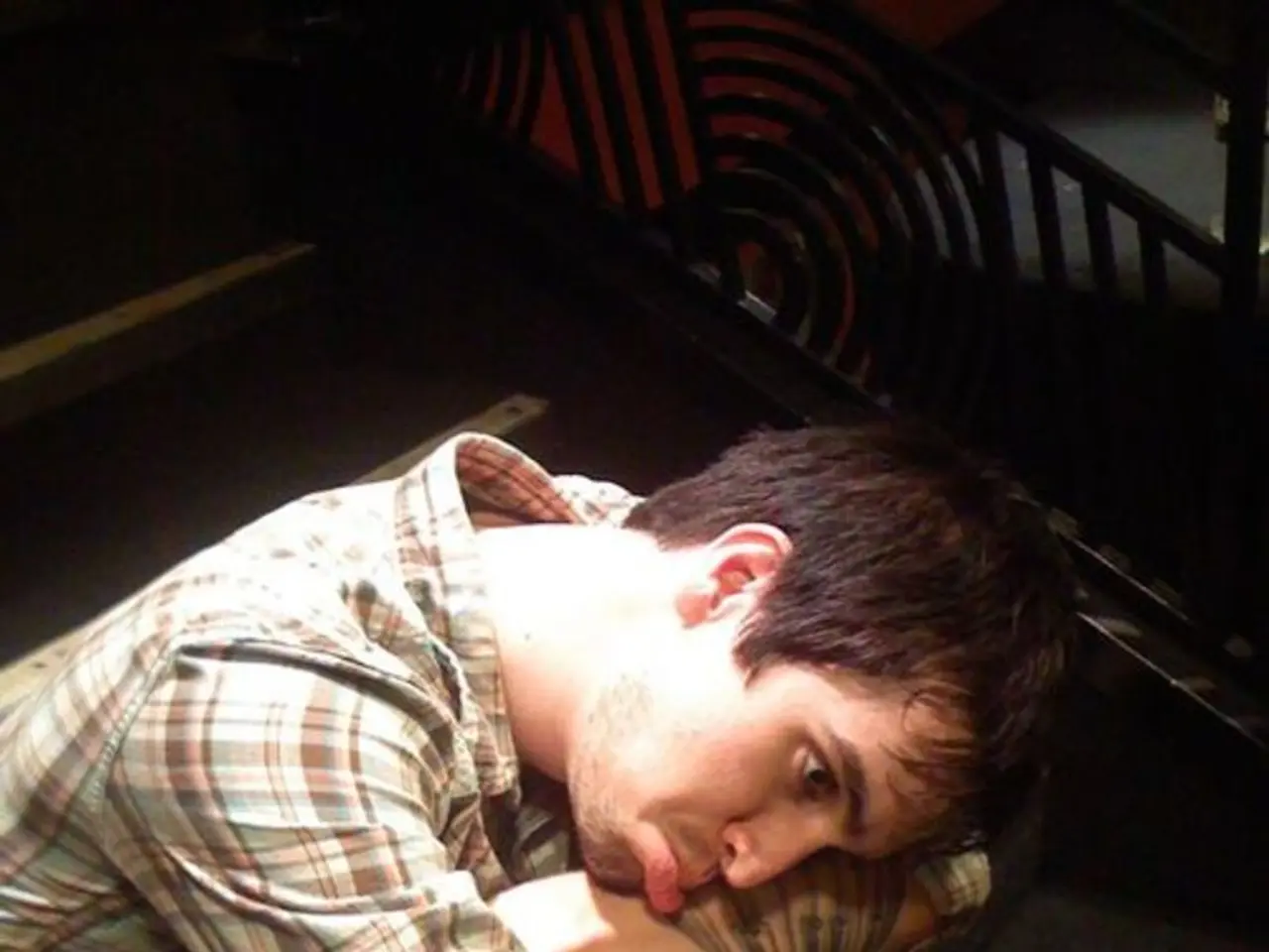 Here in this picture we can see a person sitting on a stair case and making a sad face and beside...