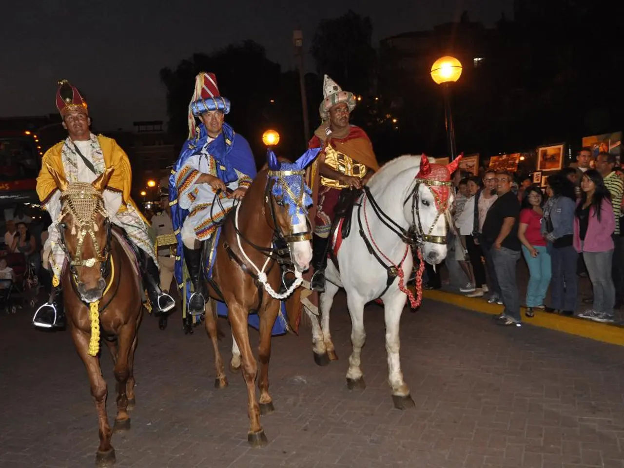 In this image there are three persons sitting on the horses , and in the background there are group...