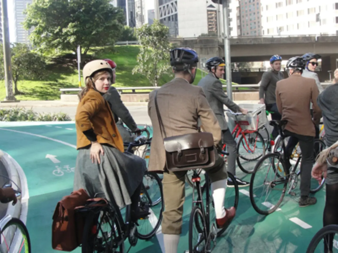 in the picture there are many people wearing helmet and sitting on the bicycle,there is...