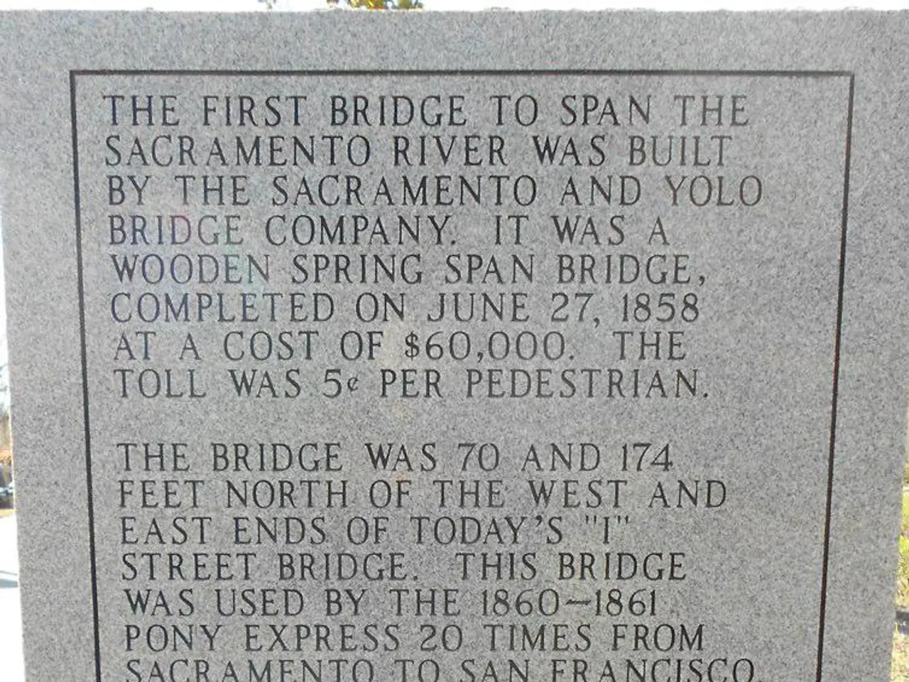 In this image I can see a headstone on which matter is written.