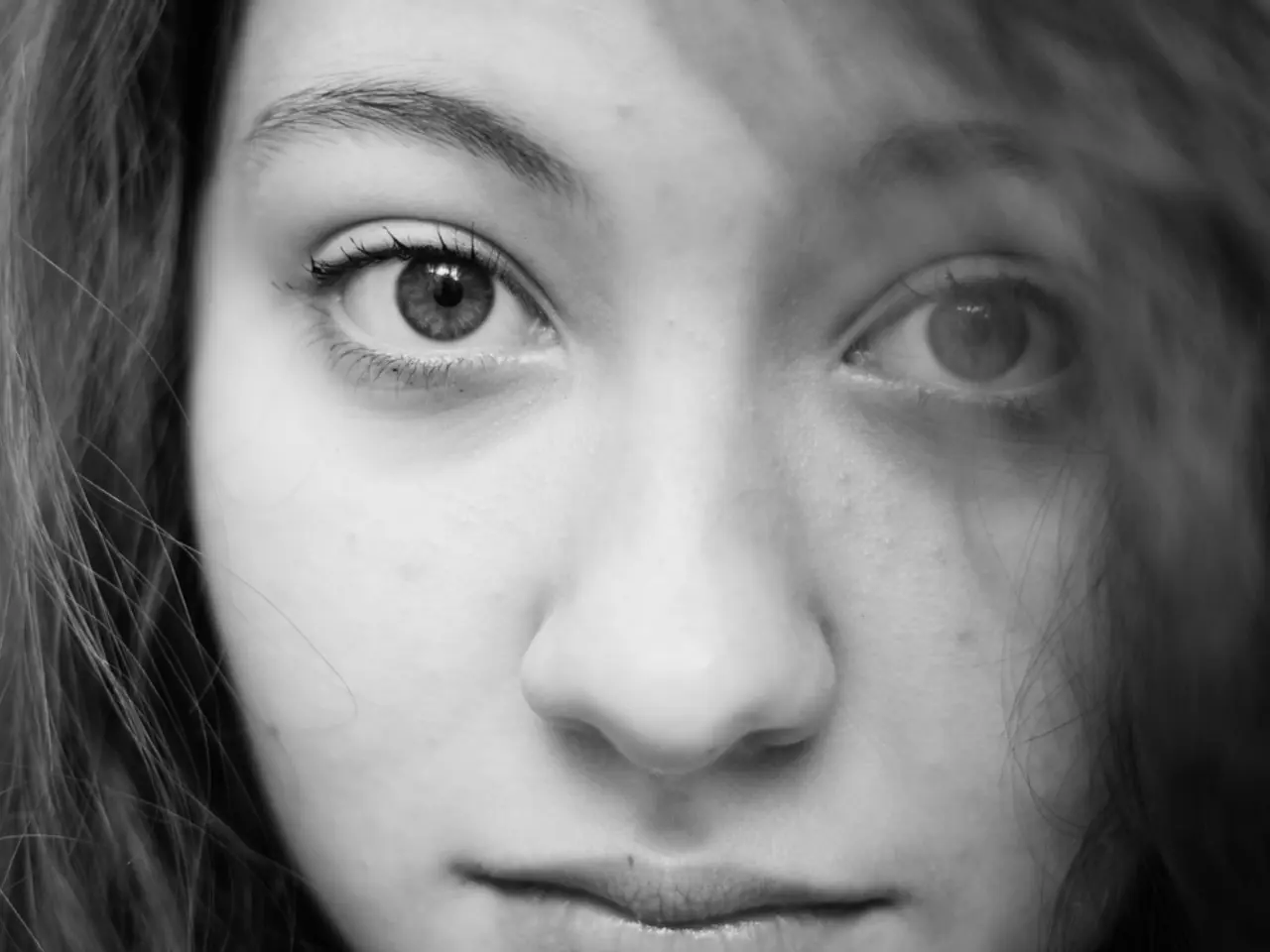 In this picture there is a woman with black hair and she has two eyes, one nose and mouth.