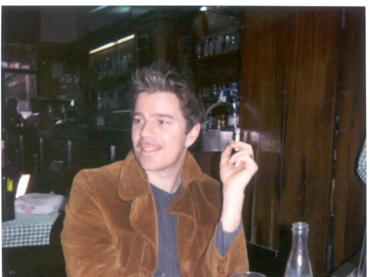 The photo is clicked inside a restaurant. In the middle one person wearing a brown jacket is...