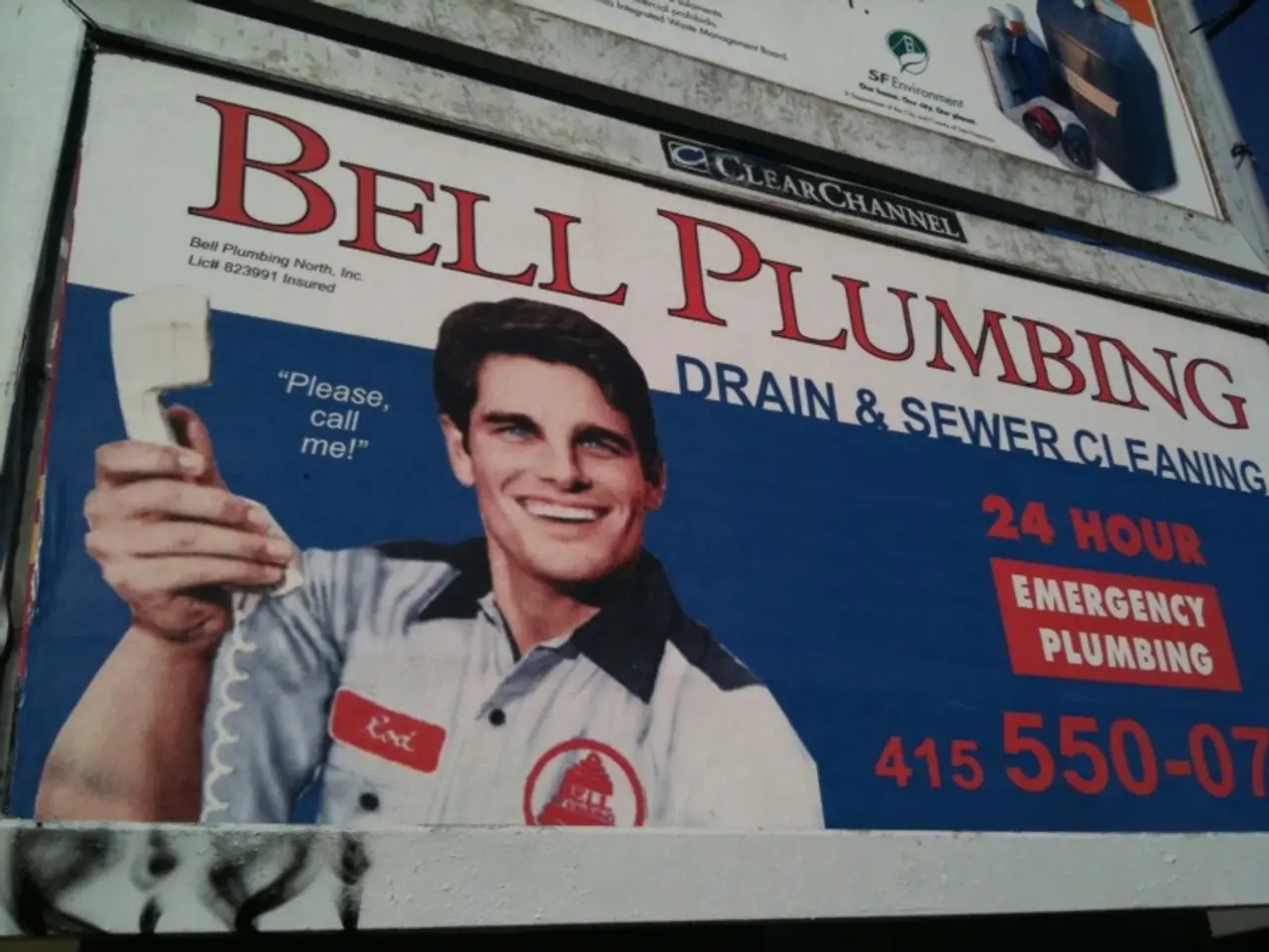 In this picture we can see hoardings, in the hoarding we can find a man, he is holding a telephone.