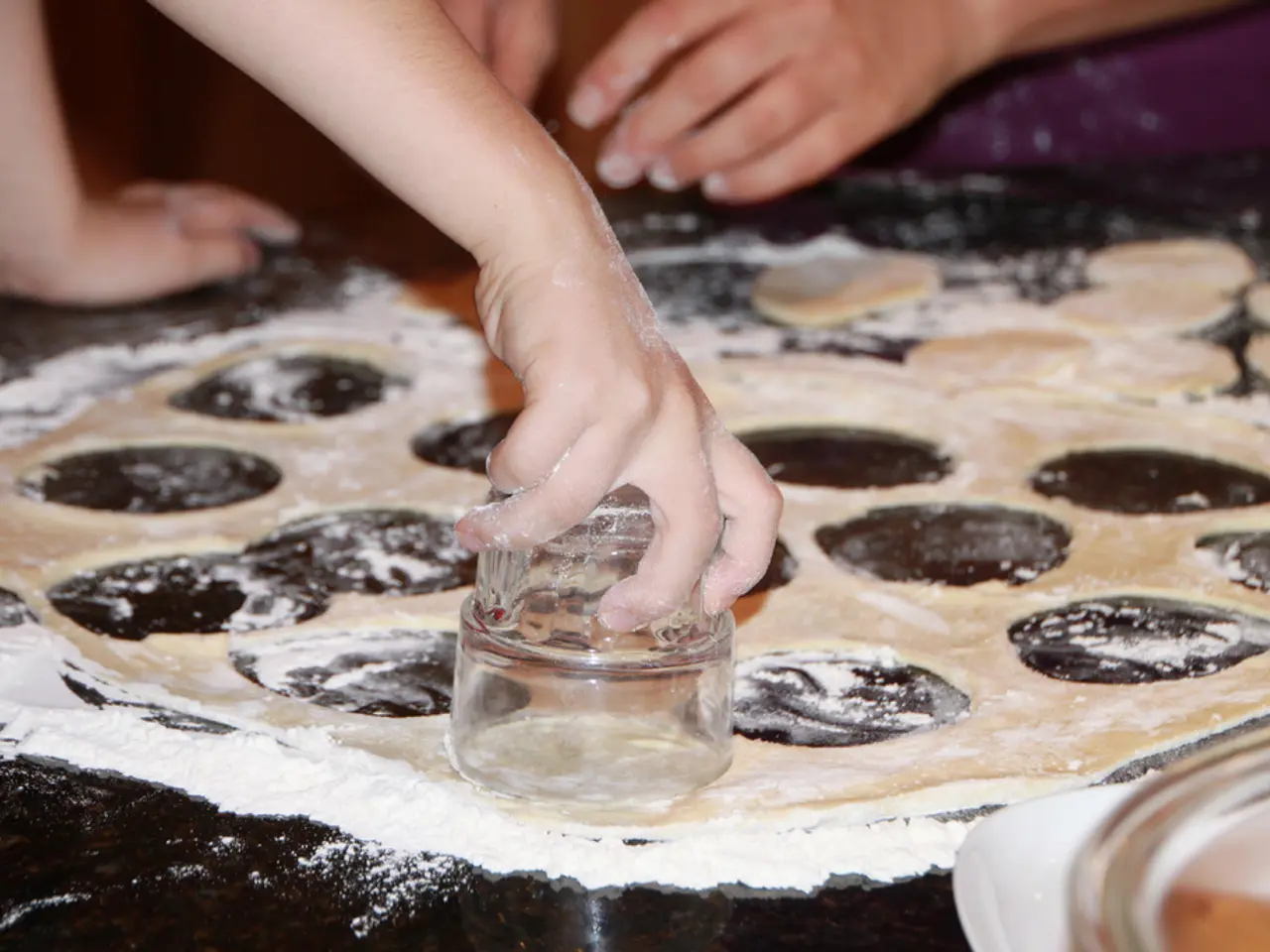 In this picture there are flour, batter, glass, people and a box.