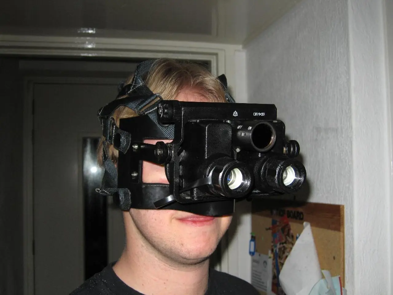 In the center of the image there is a person wearing VR headset. In the background there is door.