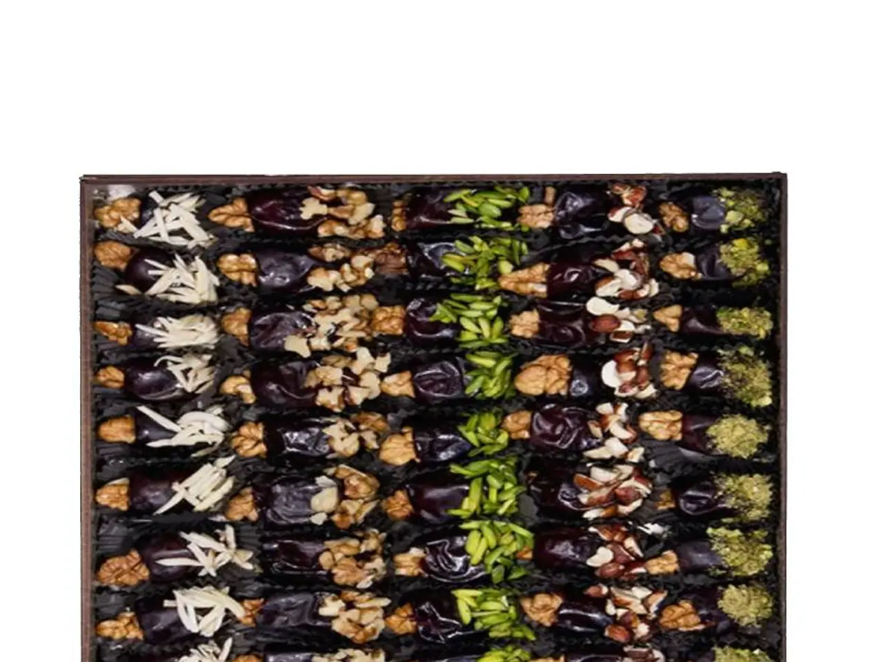 The image shows a box filled with a variety of dried fruits and nuts on top of a white background....