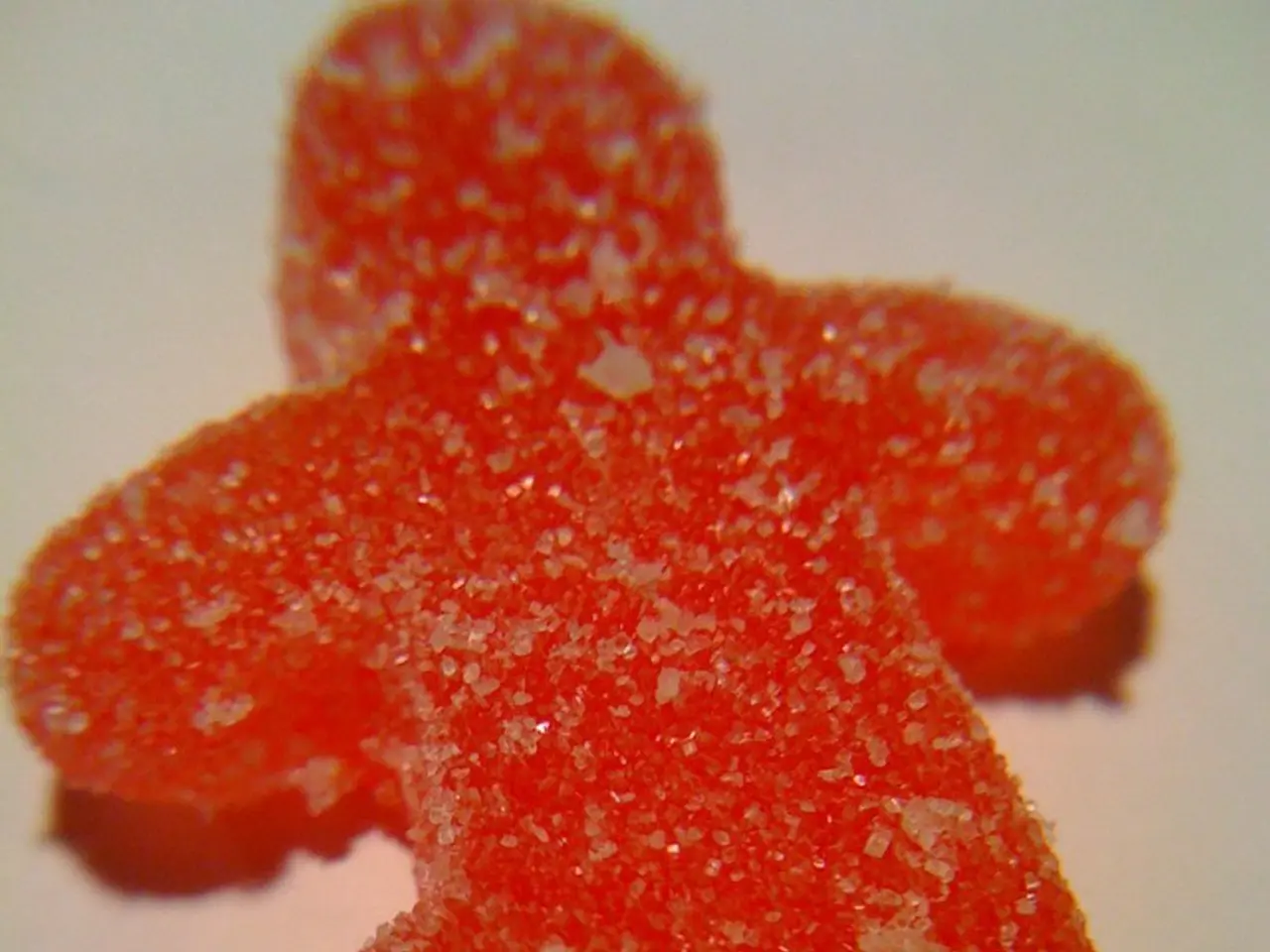 In this image there is a candy coated with sugar.