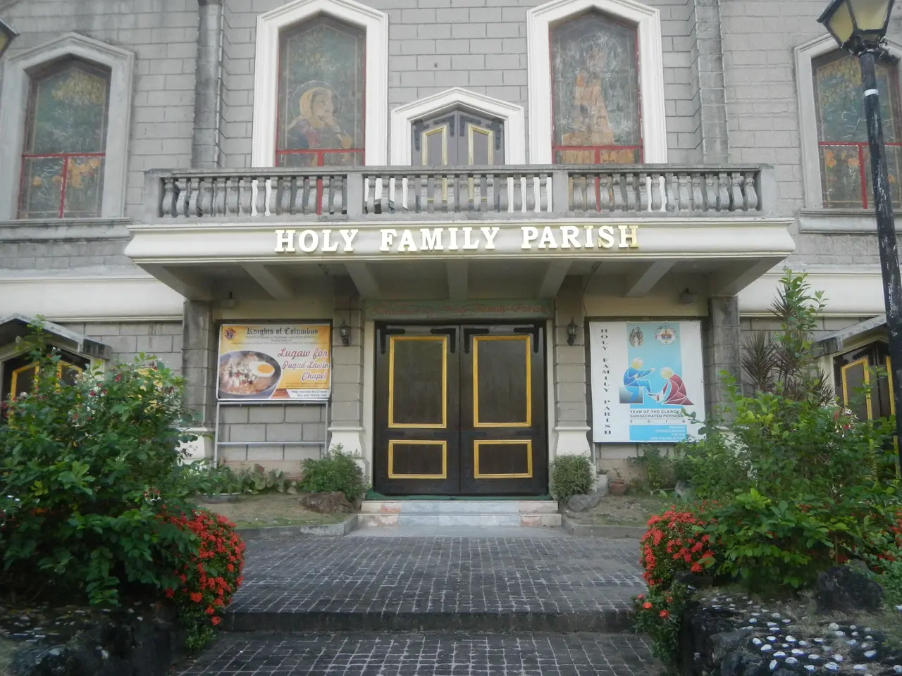 The image shows the Holy Family Parish in Manila, Philippines. It is a building with windows,...