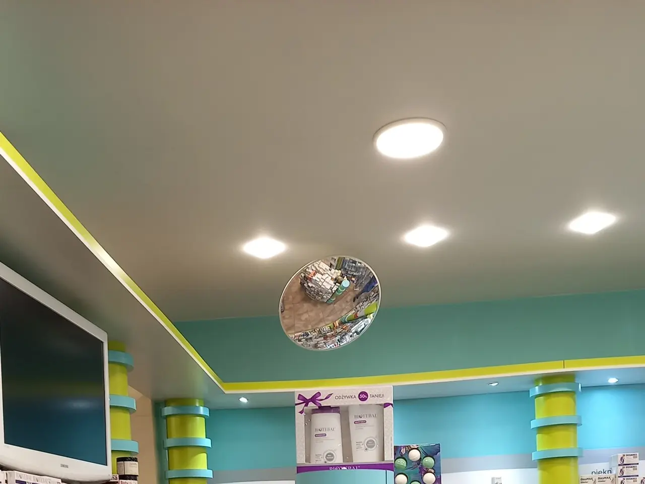 The image shows a pharmacy with a counter filled with lots of different types of medicines,...