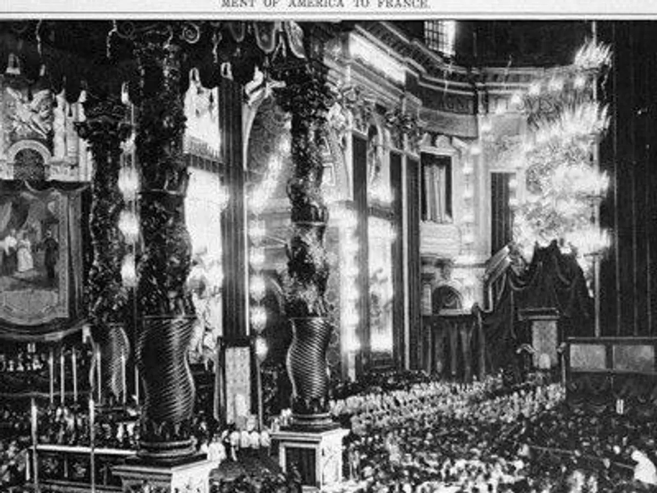 The image shows a black and white photo of a large crowd of people in a church, with pillars,...