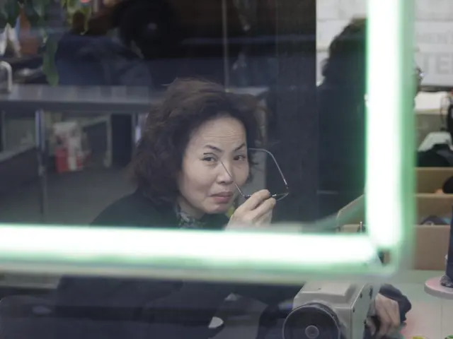 Queen Mary puts on a pinstripe Ralph Lauren trousersuit upon her return to work following her...