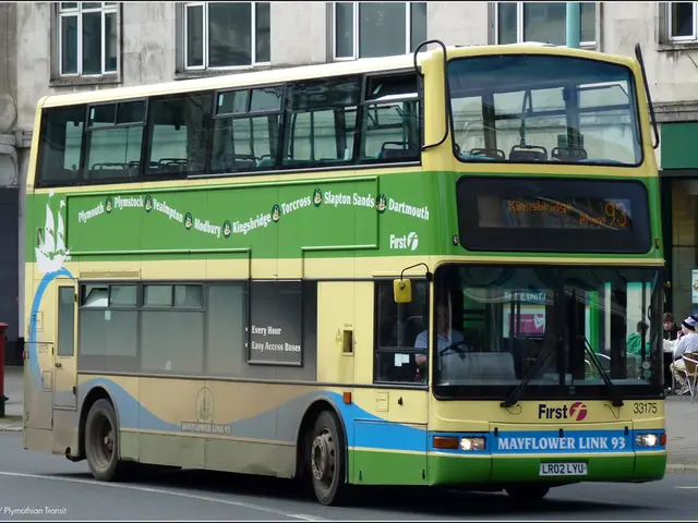 This is an outside view. Here I can see a double-decker bus on the road. Inside the bus there is a...