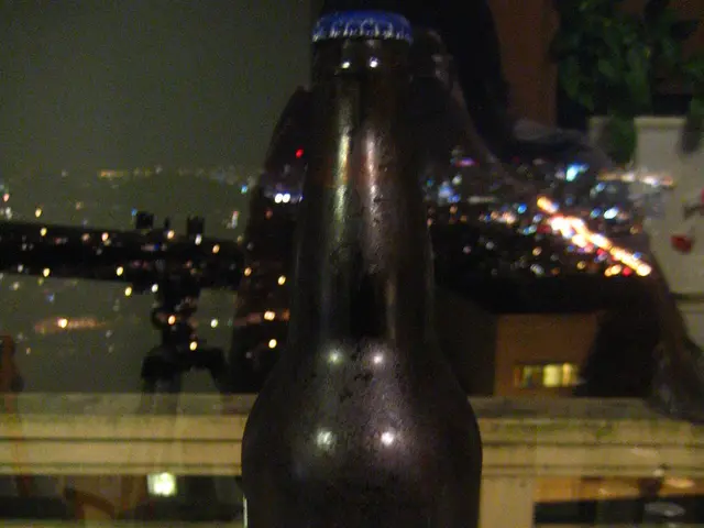 This black bottle is highlighted in this picture. Far there are lights.