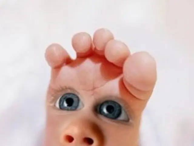 In this image we can see an edited picture. In the center of the image we can see leg of a child,...