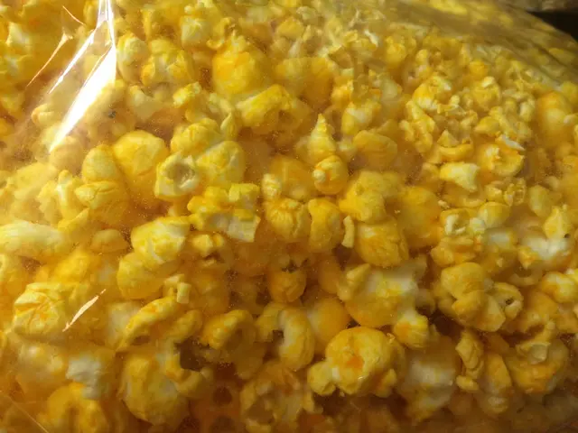In this image, I can see the popcorn, which is packed in a plastic cover.