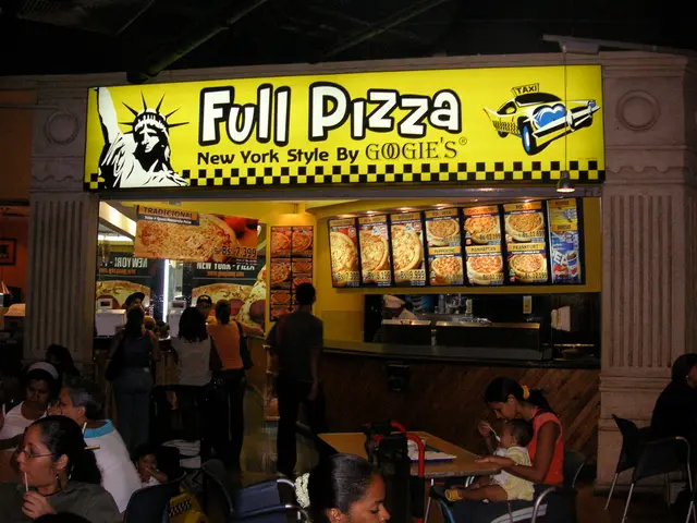 In this picture there are people standing here and some of them are sitting and having their meal...