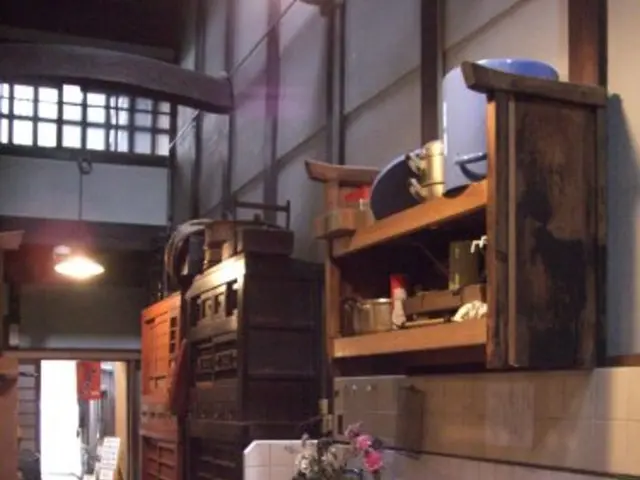 In the given image i can see a wash basin,wooden draw,flower pot,taps,wooden...