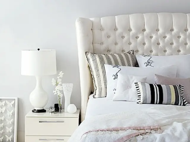 On the left we can see desk, lamp, flower vase, frame, wall and other objects. On the right we can...