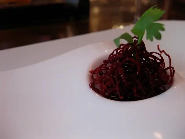 In the image I can see a food item on which there is a leafy vegetable.