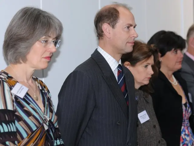 In this image I can see a group of people are standing and looking at the right side, few of them...
