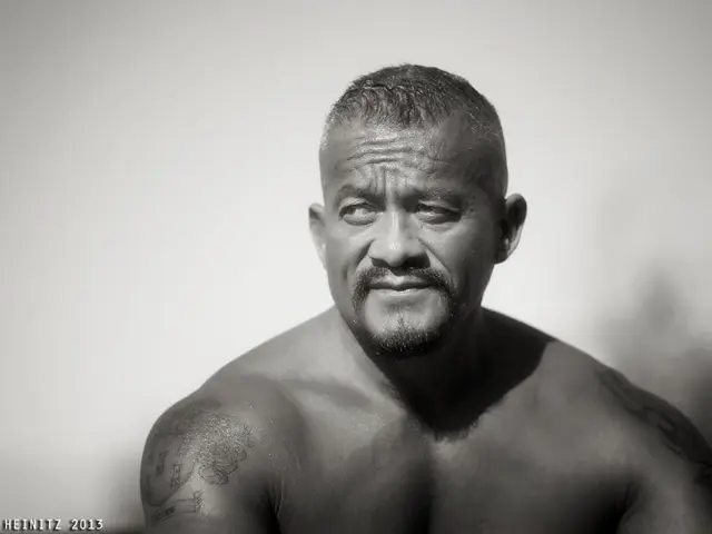 This is a black and white image. Here I can see a man looking at the left side. The background is...