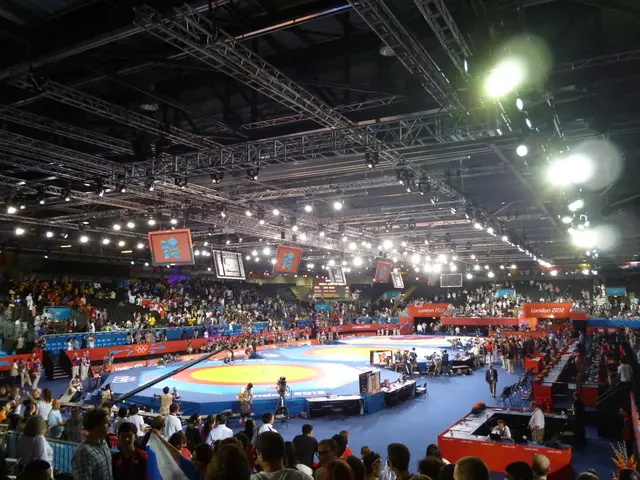 In this image we can see the Indoor stadium where we can see these people are in the ground and...