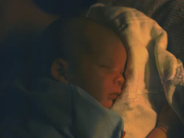 In this picture I can see a baby who is lying on a cloth.