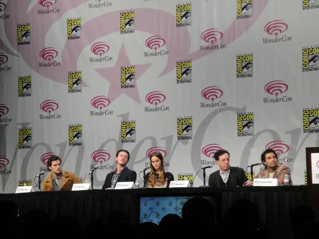 There are people sitting in the foreground area of the image, there are mice and place cards on the...