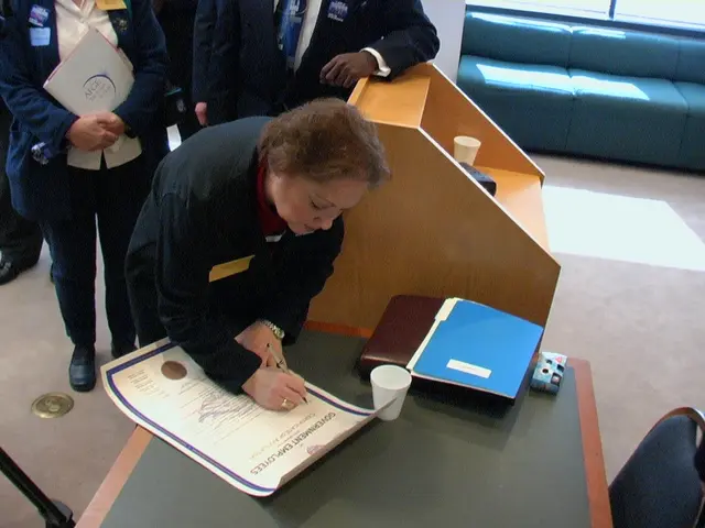 Here we can see few persons and she is writing on the paper. This is table. On the table there is a...