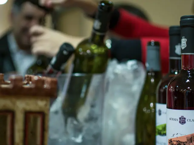 As we can see in the image, there is man. In the front there are few bottles.