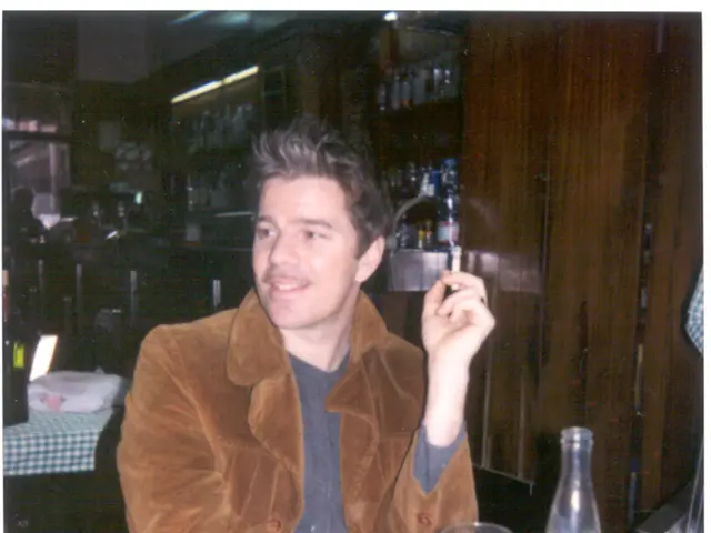 The photo is clicked inside a restaurant. In the middle one person wearing a brown jacket is...