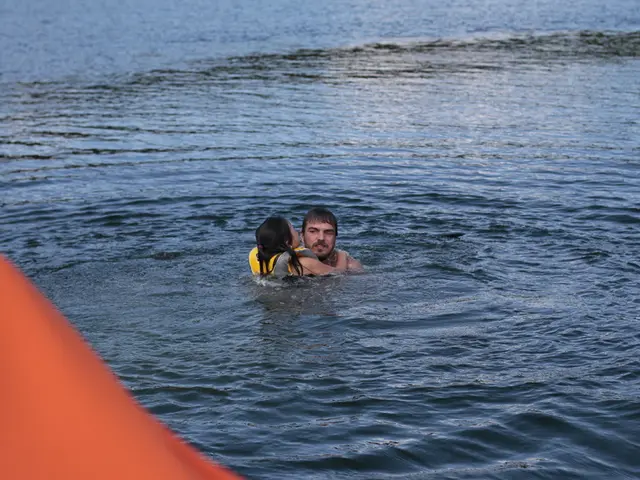 In this picture we can see few people in the water and a person wore a life jacket.