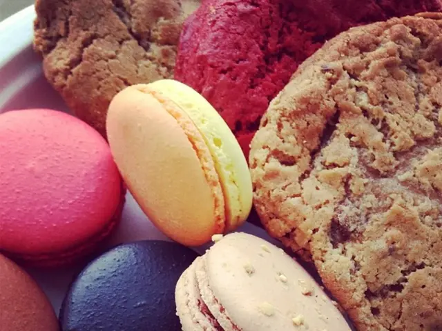 In the image we can see Macaroon biscuits and other food items.