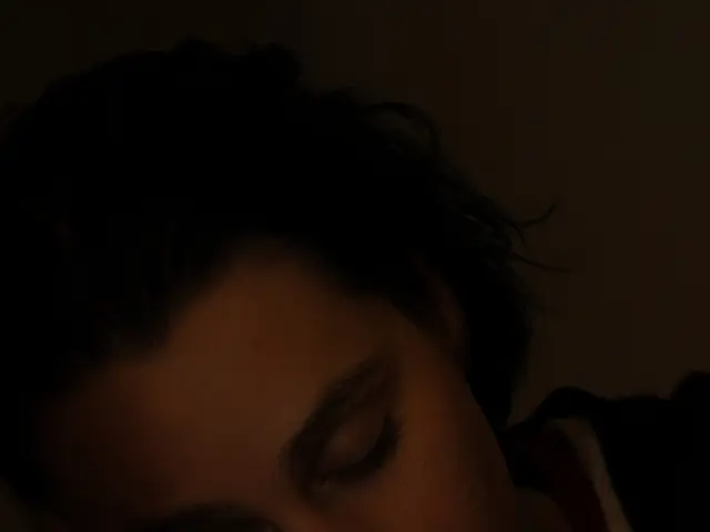 In this picture we can see a person sleeping. There is a dark view on top and at the bottom of the...