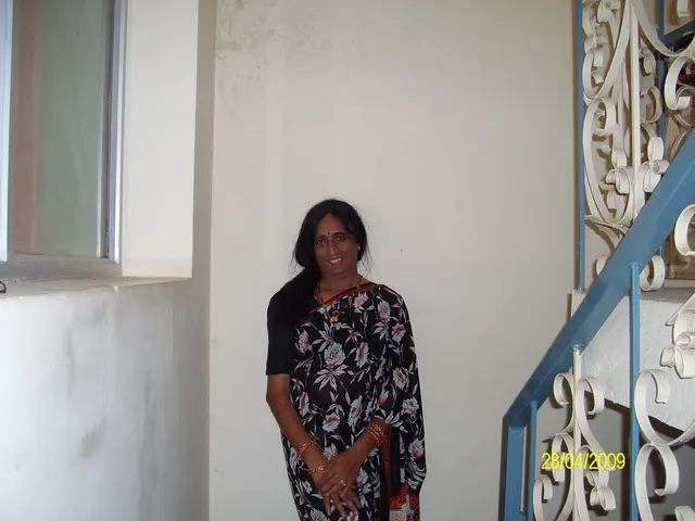 At the bottom of this image, there is a woman in sari, smiling and standing. On the right side,...