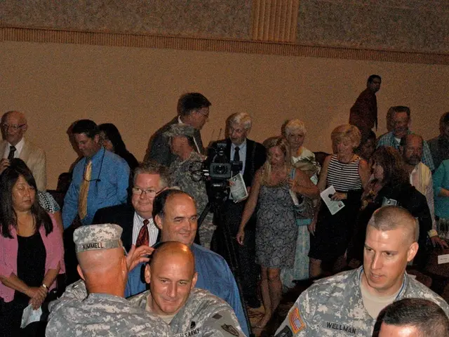 In this image there are persons standing and walking. In the center there are persons hugging each...