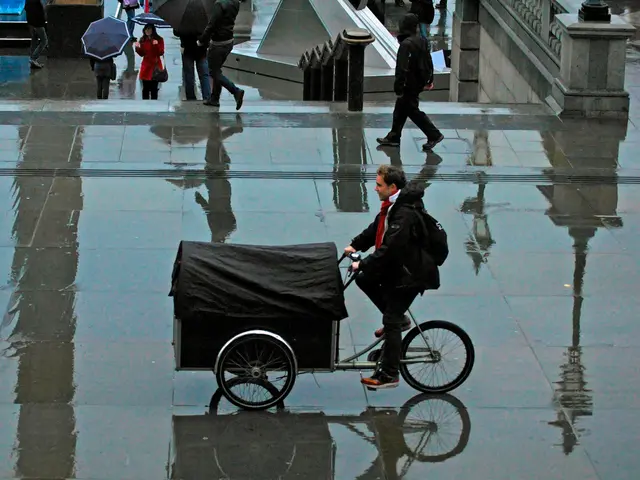 In this picture there is a person sitting on vehicle cycling it on the place. There are some people...