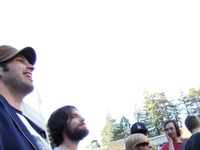 In the picture we can see some people are standing and talking to each other and some people are...