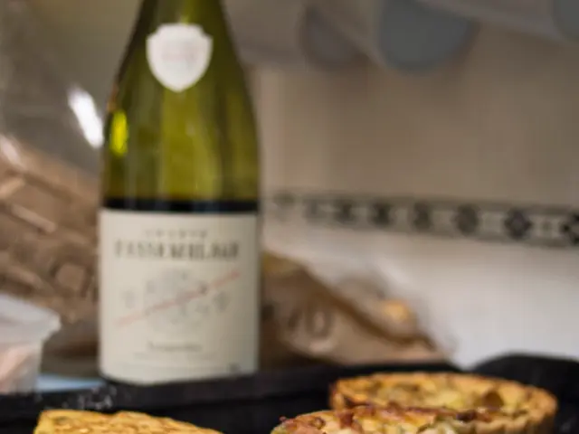 This picture shows some food items in the tray. In the background, there is a bottle here.