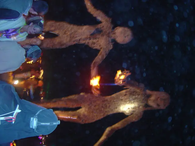 On the left side of the image there are few people. Behind them there are statues, which were...