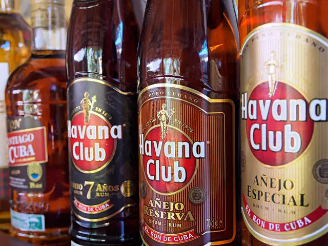 In this image there are a few bottles with some drink arranged in the shelf's and some label-lungs...