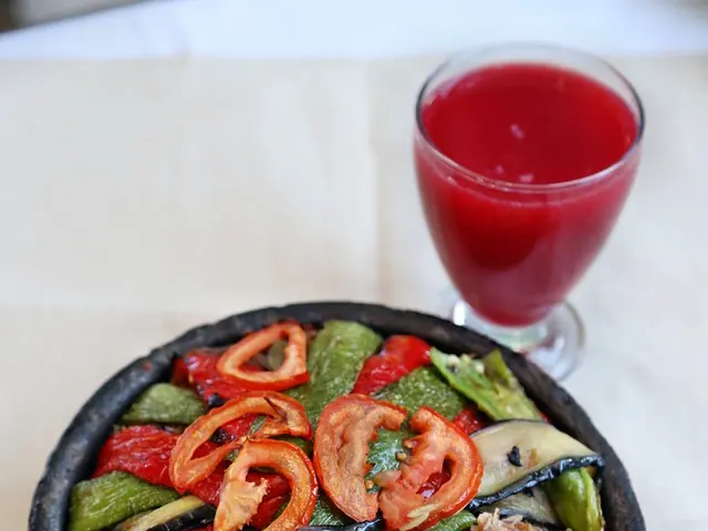 In the image there is a plate with salad and fork in it, it consists of tomato and some veggies,...