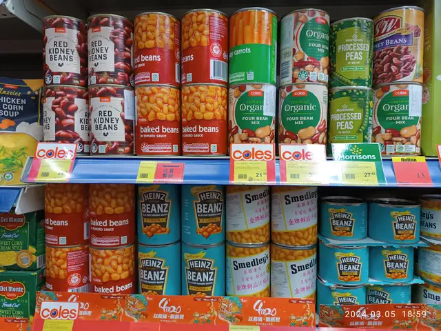 The image shows a store shelf filled with lots of different types of canned food, including boxes...