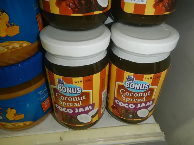 The image shows a shelf filled with jars of peanut butter and other food items. The jars are of...