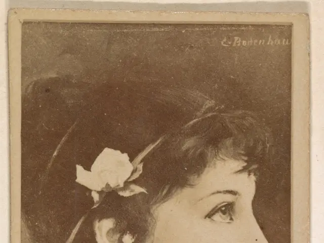 The image shows an old photo of a woman with a flower in her hair. Her face is clearly visible,...