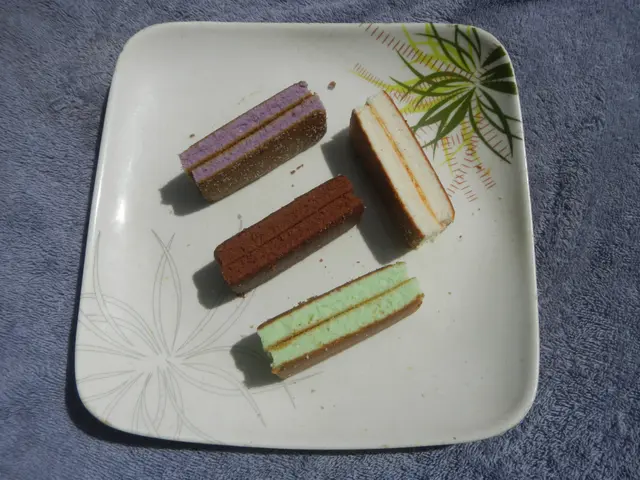The image shows a white plate on a table, topped with four different types of ice-cream sandwiches....