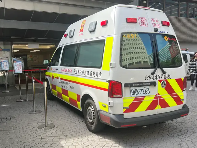 The image shows an ambulance parked in front of a building, with a group of people walking on the...