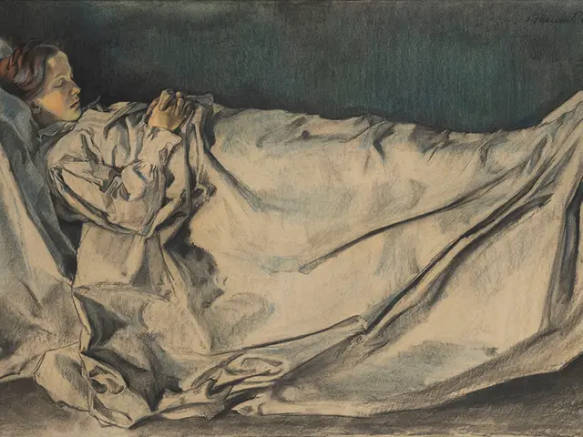 The image shows a woman laying in bed with a blanket draped over her head, her face illuminated by...